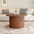 Walnut-finish Daydreamarc round coffee table shown in front of a sofa