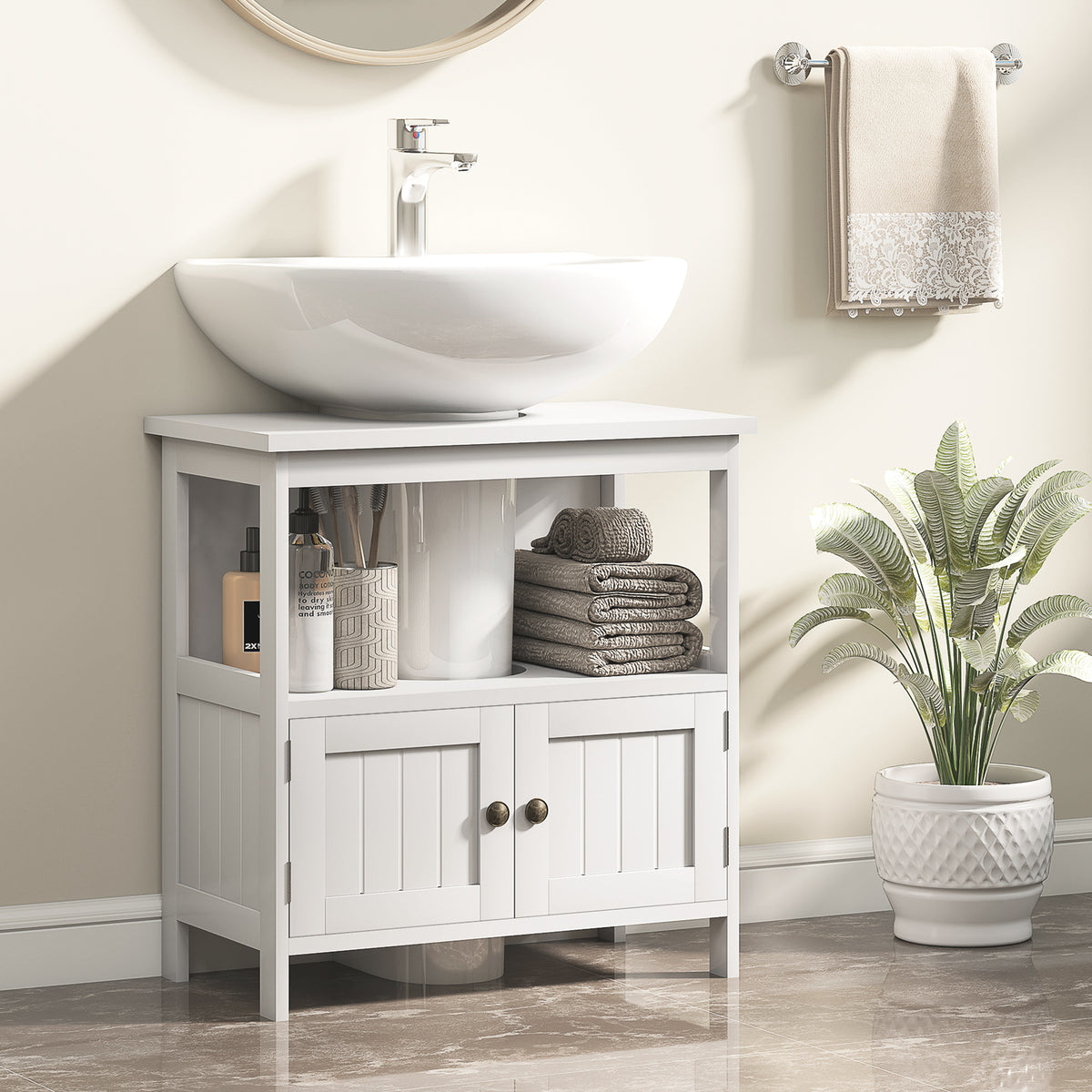White Kleankin cabinet fitted around a pedestal sink in a bathroom with towels and toiletries on the open shelf