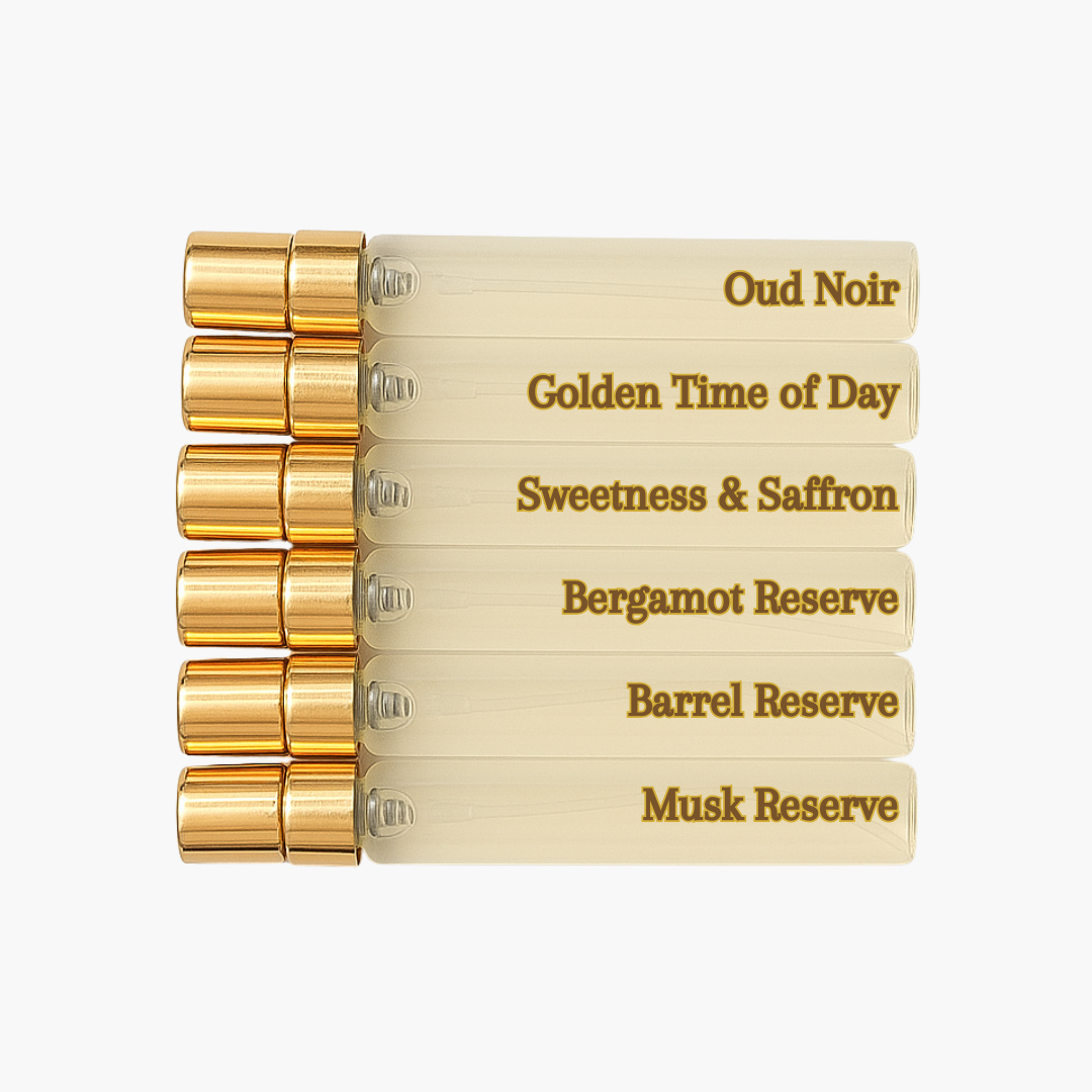 Set of perfume bottles with gold caps and beige labels on a white background