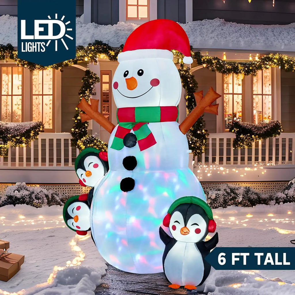 Snowlisse: Angled view of the 6 ft snowman inflatable with three penguins and multicolor lights