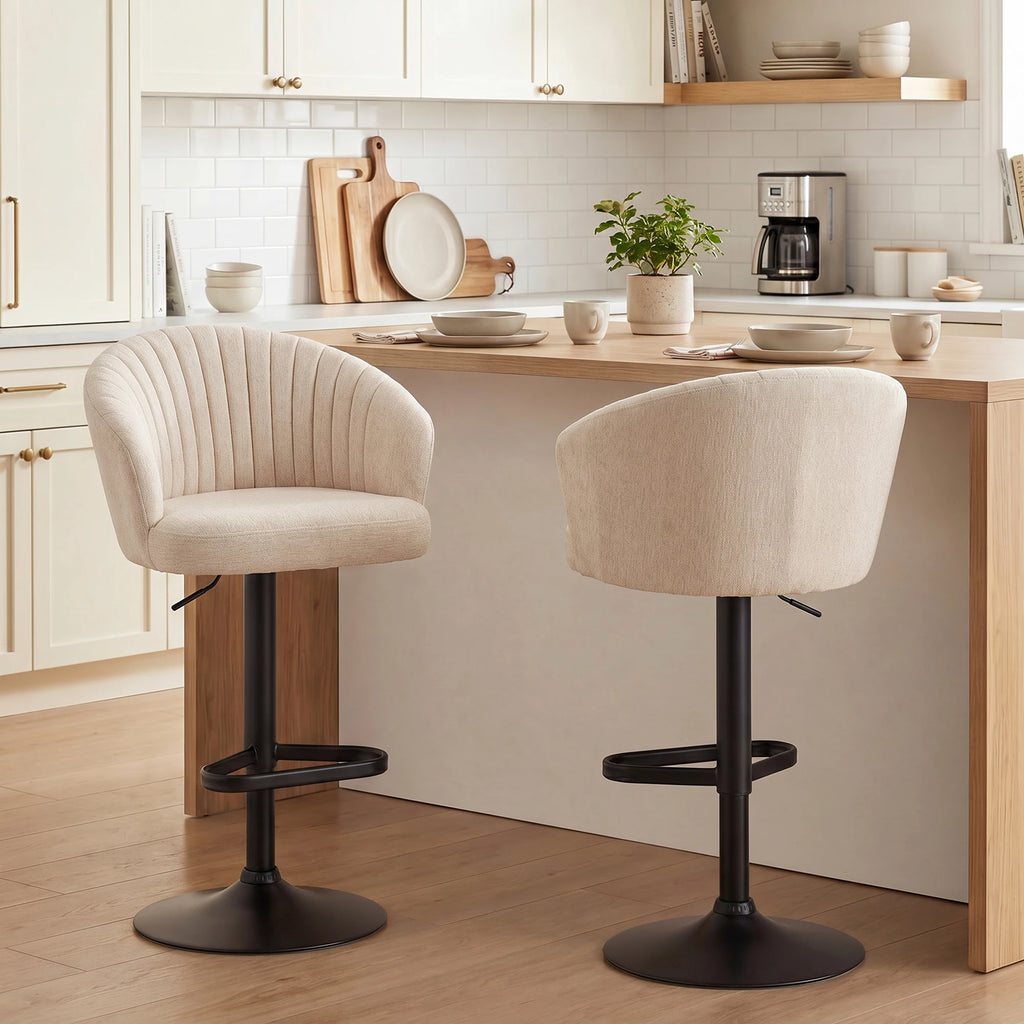 Avelisse beige stools with padded barrel backs, black bases and integrated footrests
