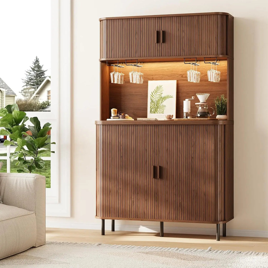 Sablenote brown cabinet with rounded corners, fluted doors and hanging stemware holders.