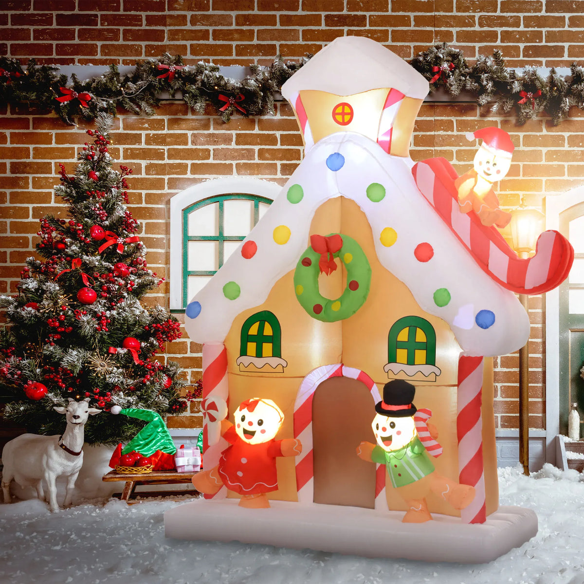 Gingerhaven illuminated gingerbread house beside a Christmas tree at a decorated entrance