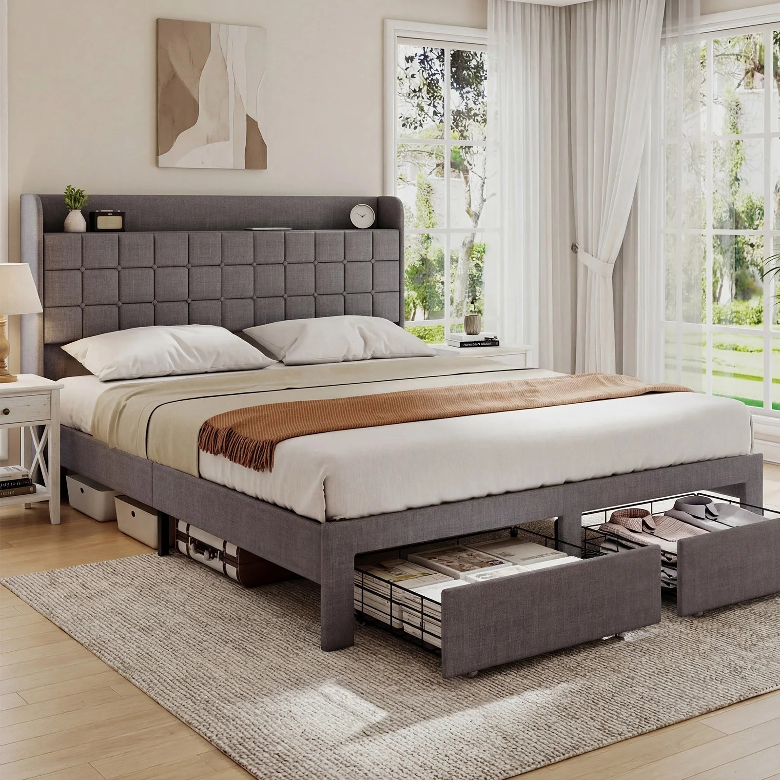 Gray upholstered bed with storage drawers in a bright bedroom