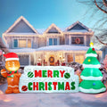 Gingerwish Merry Christmas inflatable sign with one gingerbread figure and one decorated tree.