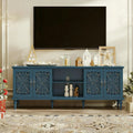 Deep blue carved Gildleaf media console below TV in living room