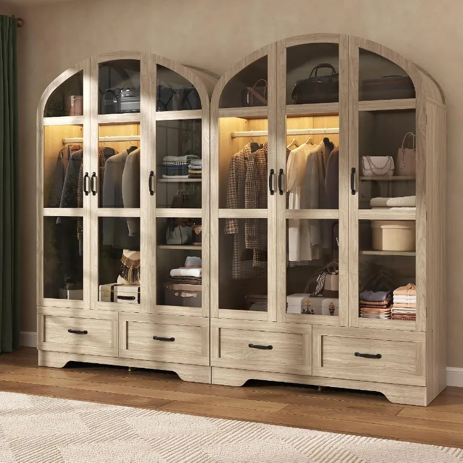 Paired bedroom arrangement of natural wood-look wardrobes with arched tops and four drawers across both units.