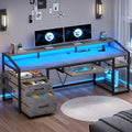 Gray computer desk with blue lighting, raised monitor shelf, keyboard tray, two drawers and open right shelves.
