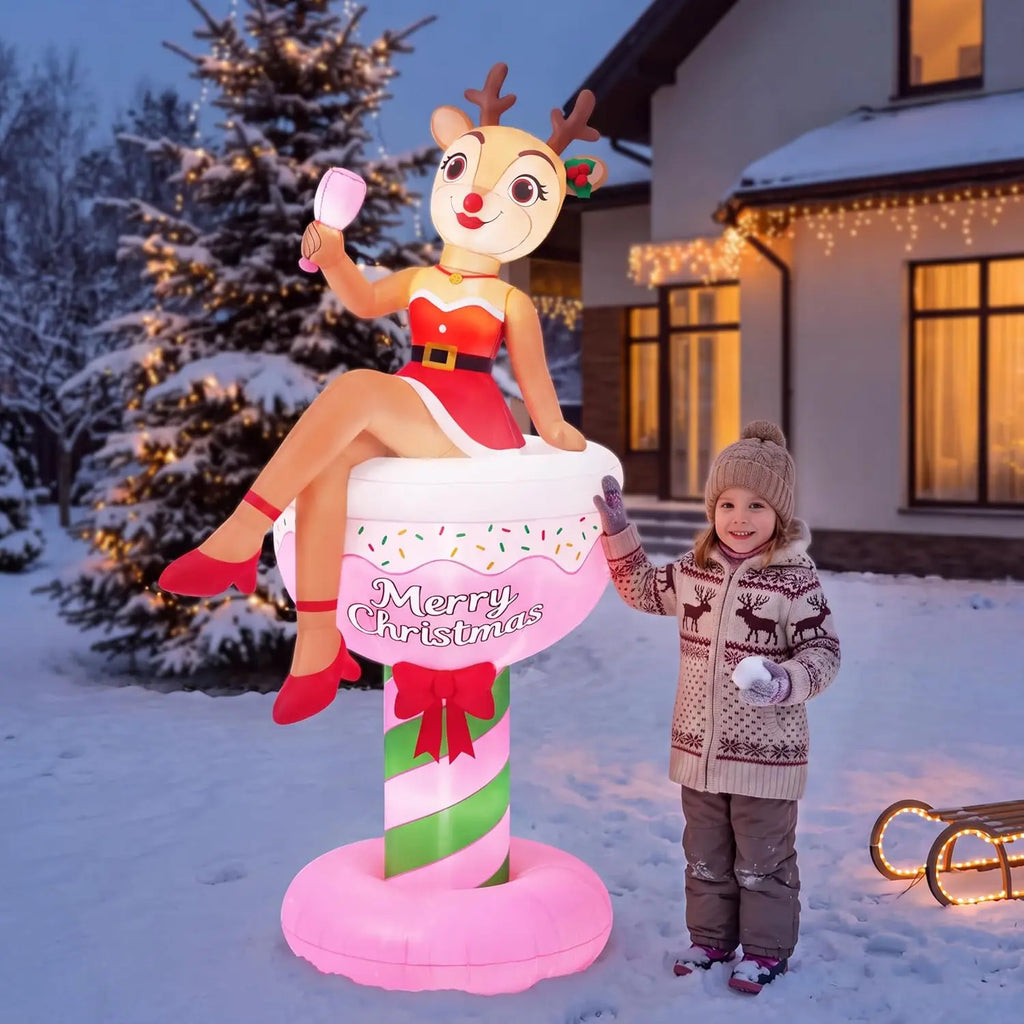 Fizzbelle reindeer character lounging in a pink cocktail-glass inflatable in a winter yard.