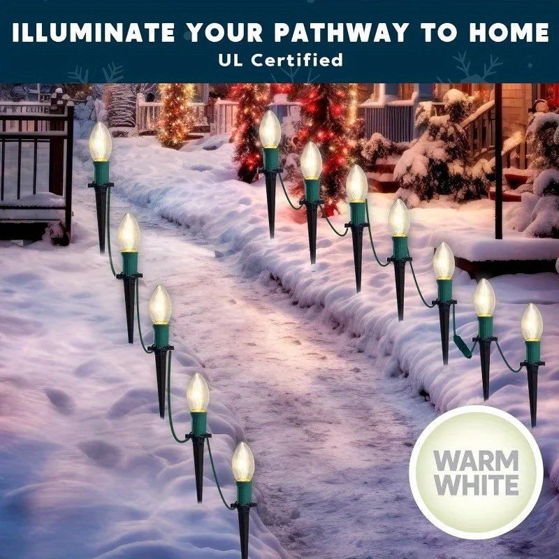 Glowtrail warm white pathway lights in a Christmas garden display.
