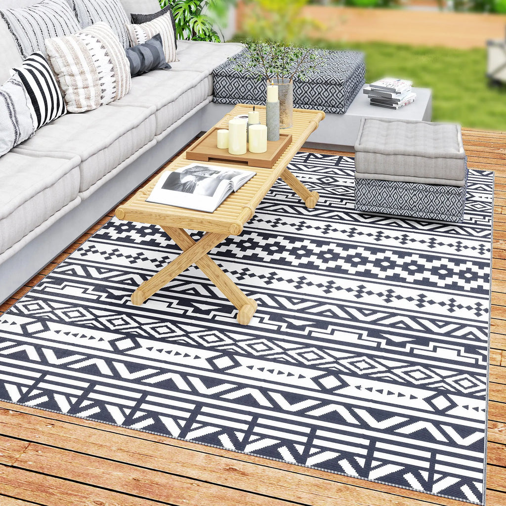 Dreamwhisper reversible blue-and-white geometric outdoor rug on a patio