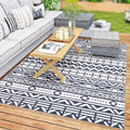 Dreamwhisper reversible blue-and-white geometric outdoor rug on a patio