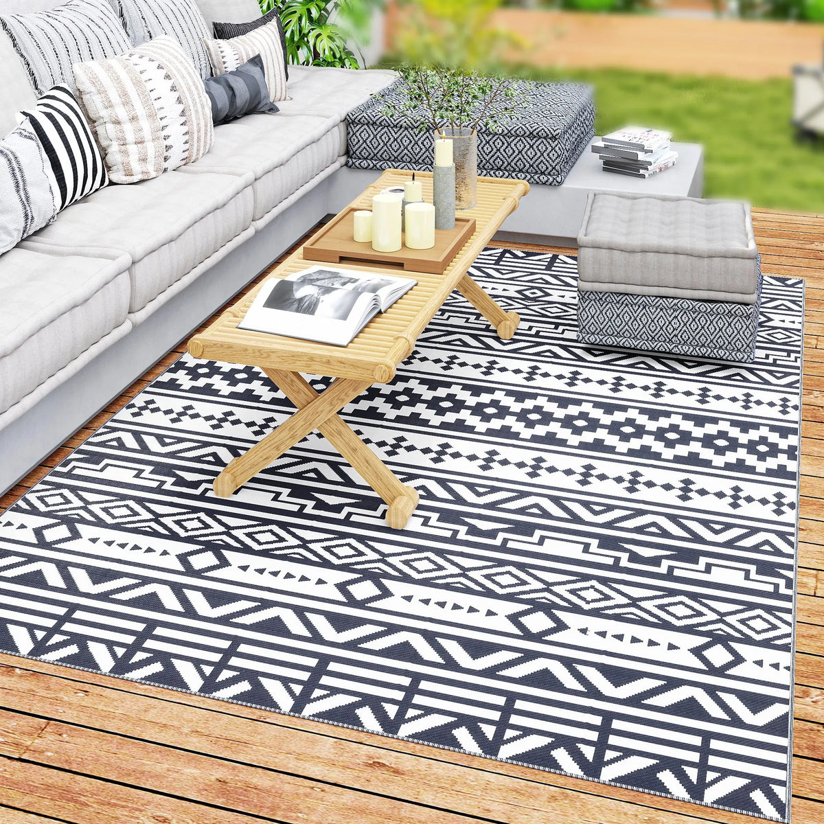 Dreamwhisper reversible blue-and-white geometric outdoor rug on a patio