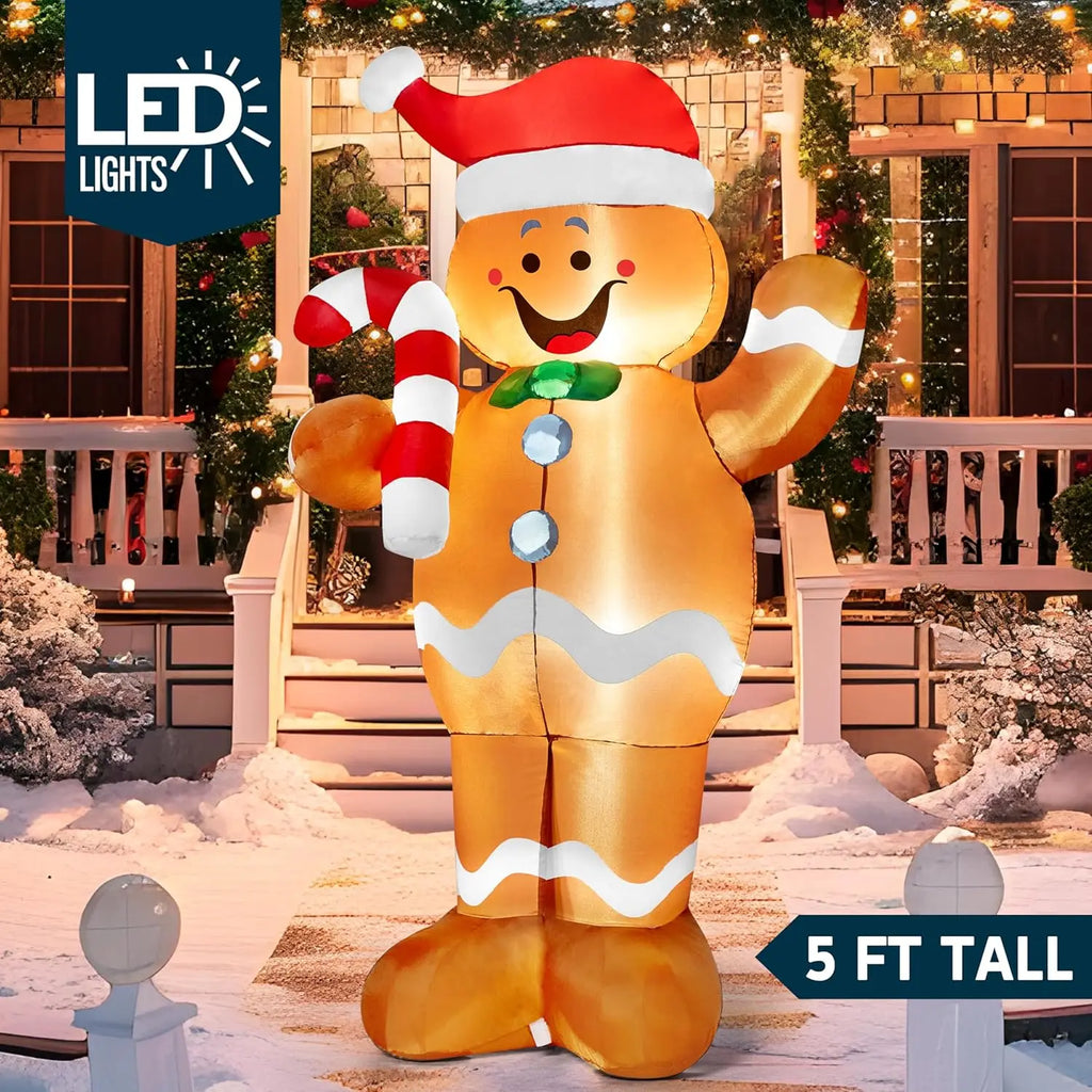 Sugarwave gingerbread inflatable with a green bow tie, Santa hat and candy cane illuminated outdoors.