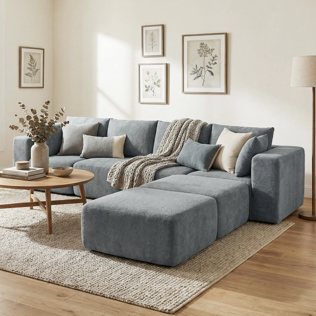 Dark gray Valegrove sectional with an ottoman and decorative cushions in a living room