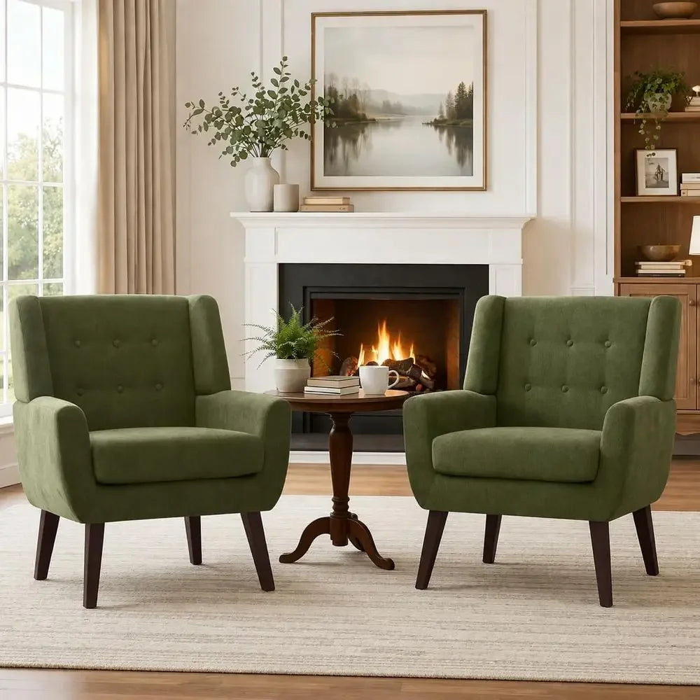 Two green button-tufted accent armchairs arranged beside a fireplace
