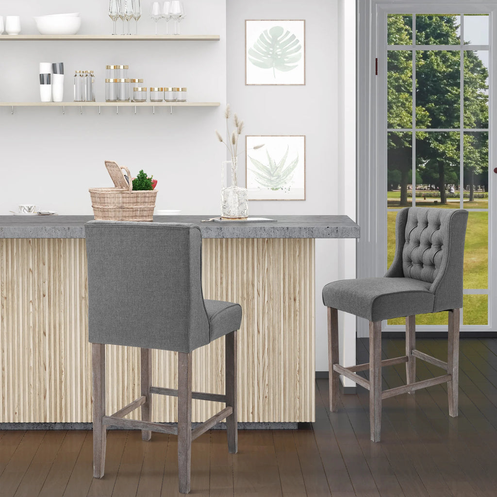 Tuftora set of two gray button-tufted counter stools with wood legs and footrests
