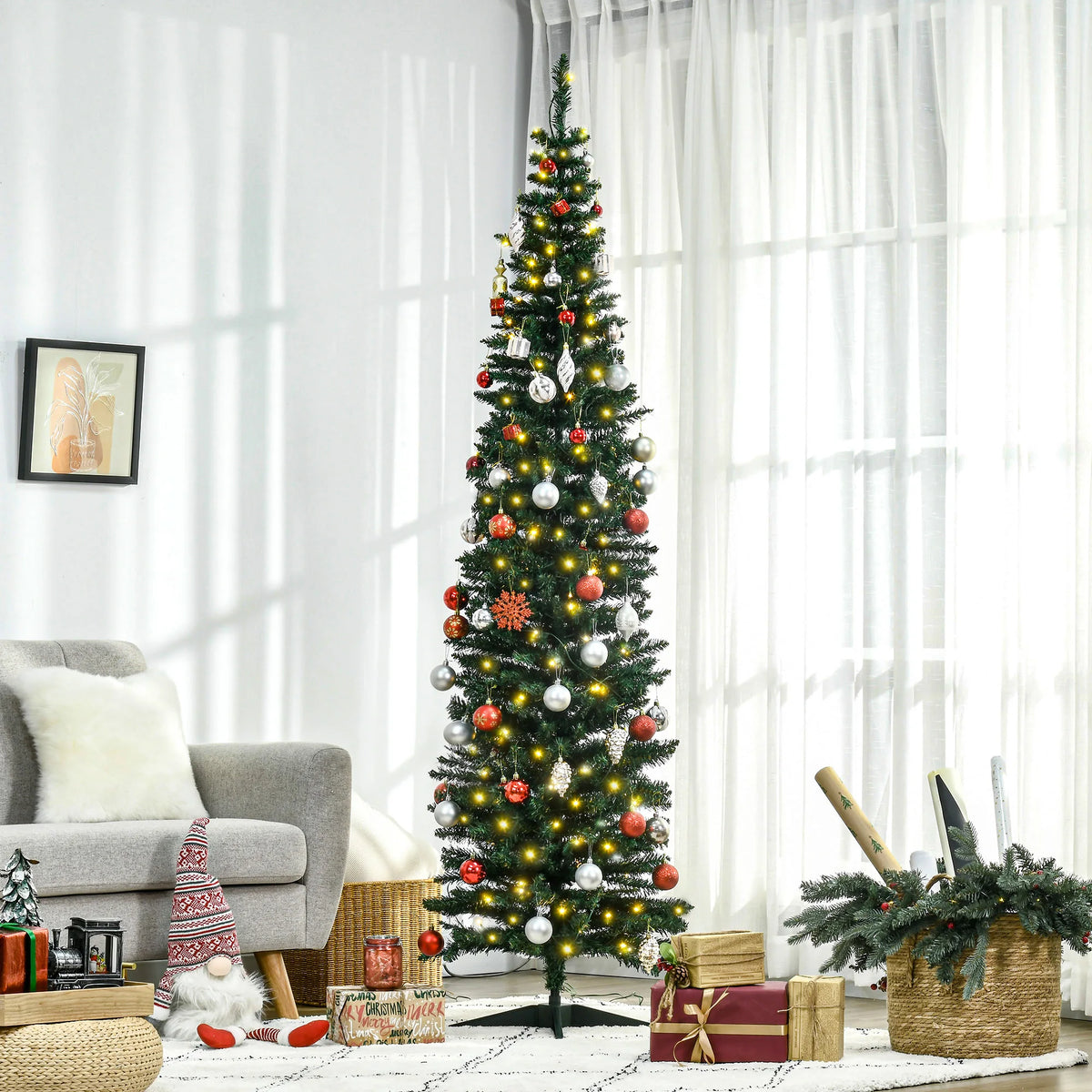 Lindenlight pencil Christmas tree styled with red and white ornaments beside a living-room window; ornaments are not included.