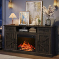 Dark wood-grain fireplace TV stand casting a warm glow in a living room at night.
