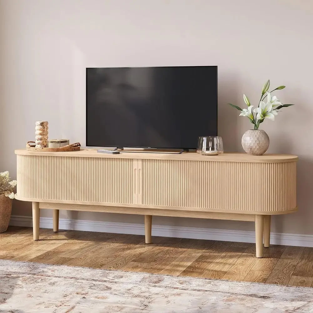 Natural wood-look Wenselle fluted TV stand with television above long rounded cabinet