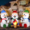 Snowmingle campfire design with three snowmen and a decorative pretend fire in a Christmas yard.
