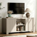 Mellorin pale wood-look media console with two handle-free doors and open center shelving.