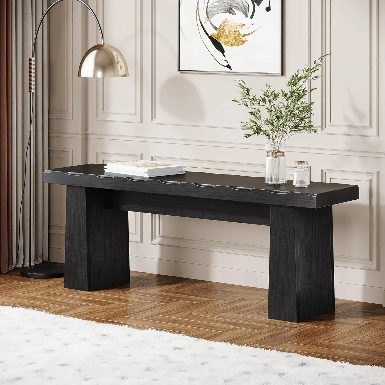 Modern black console table in a stylish room with decor elements.