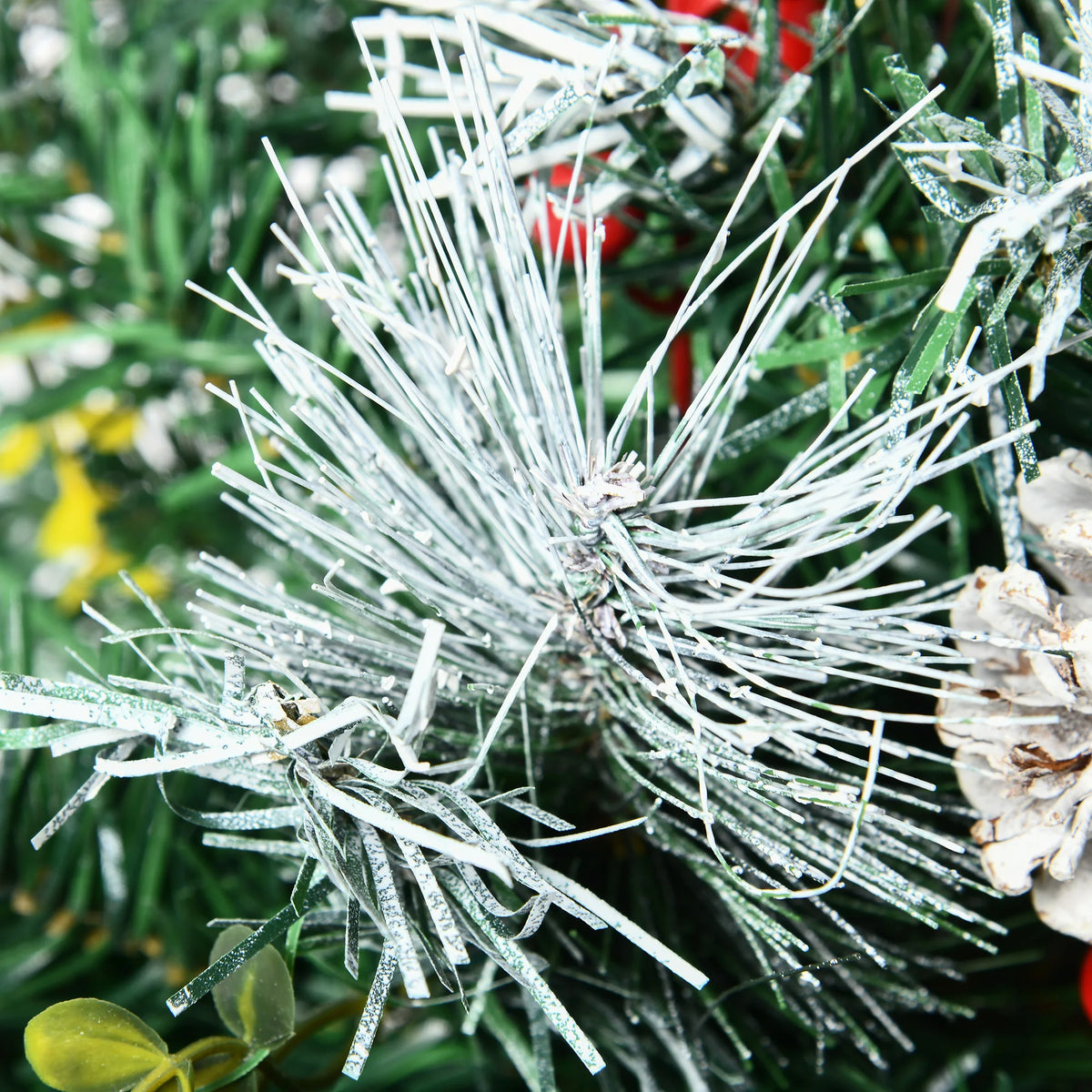 Close-up of Snowberry snow-dusted artificial foliage and holiday decorations