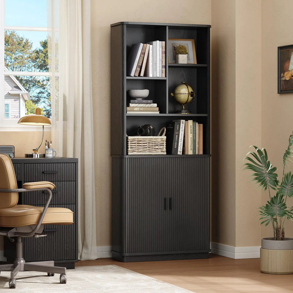 Black Hushbloom bookcase styled with books and baskets beside a home office desk