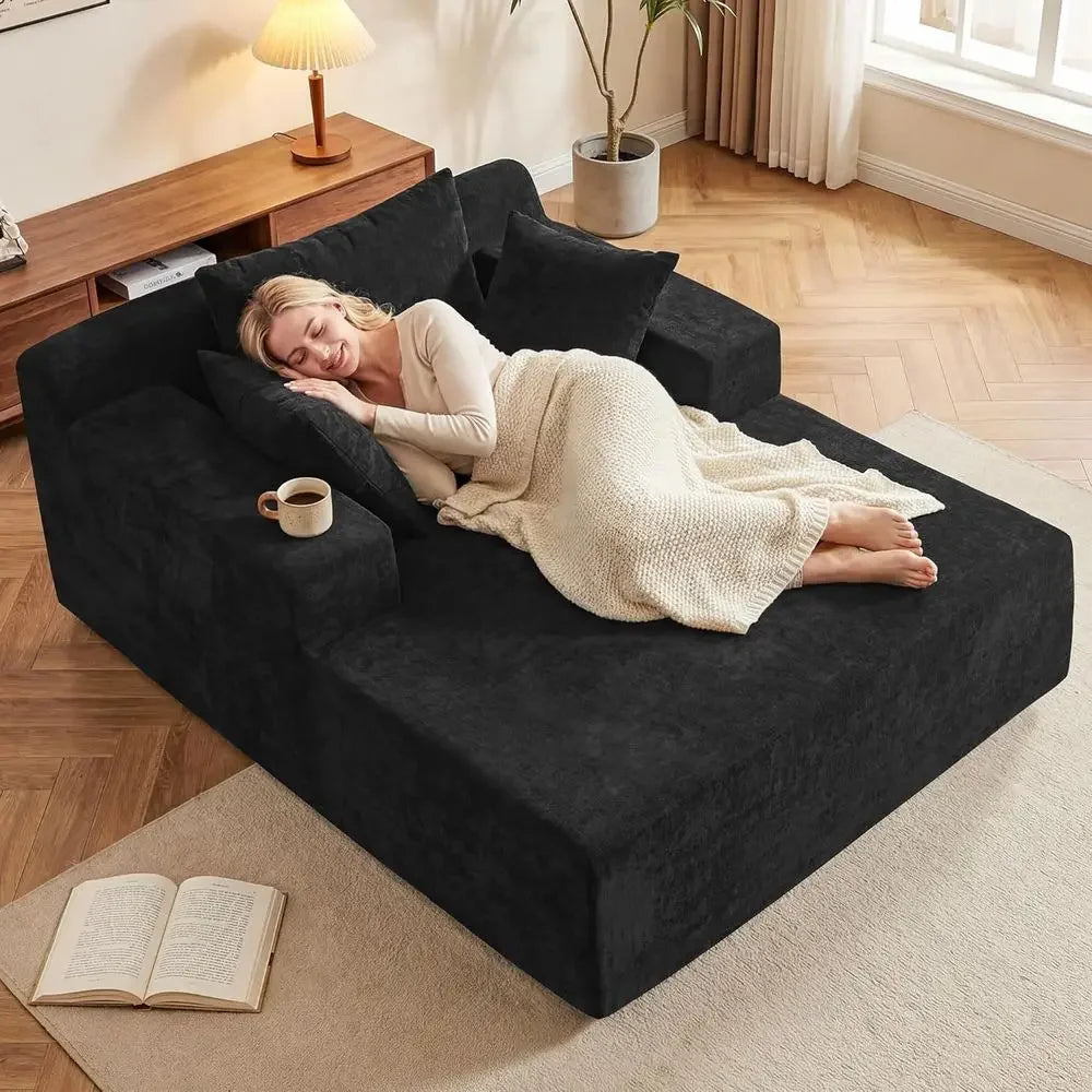 Velisette charcoal-gray chaise lounge with a woman resting on the upholstered seat