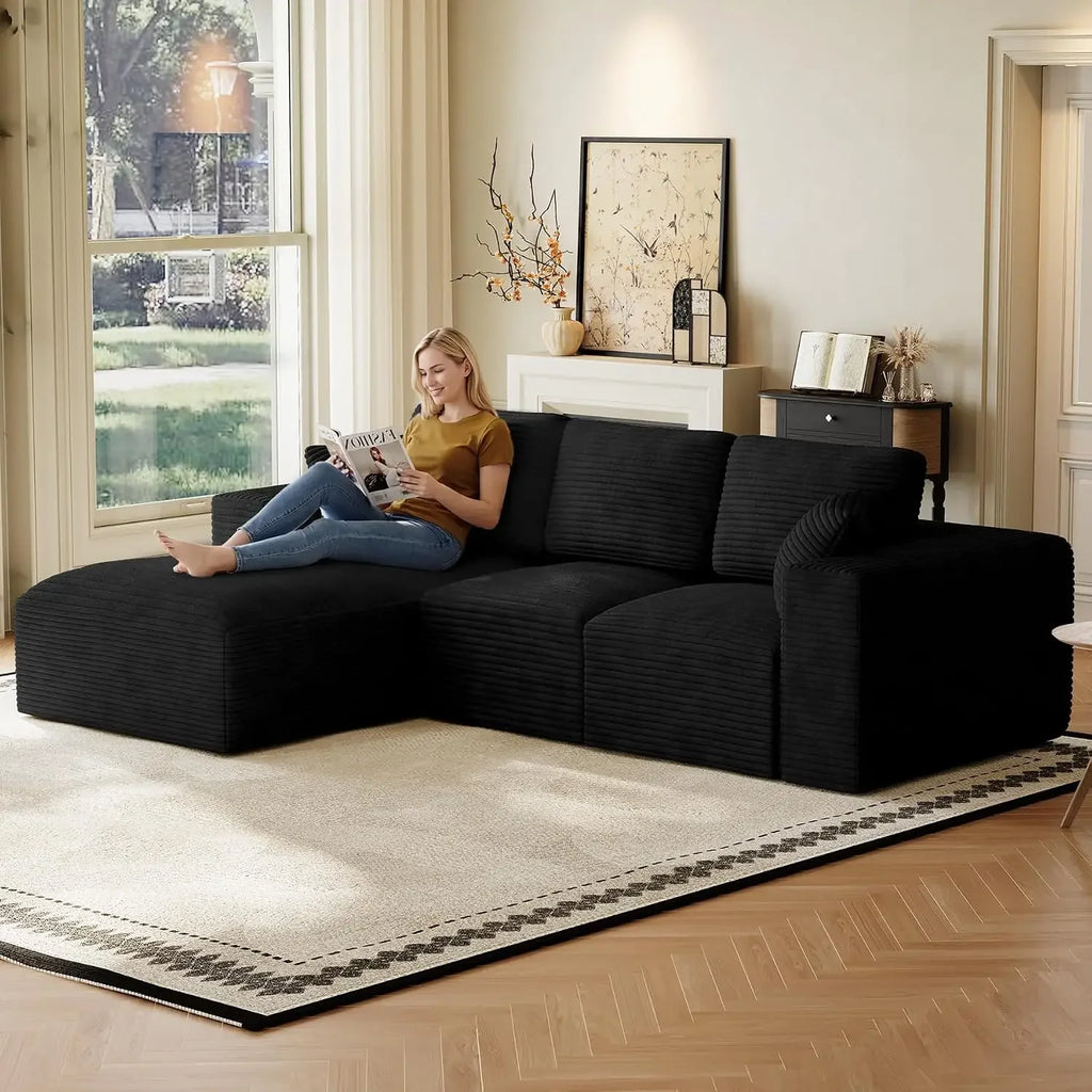 Linvere dark gray corduroy sectional pictured with person lounging on left chaise