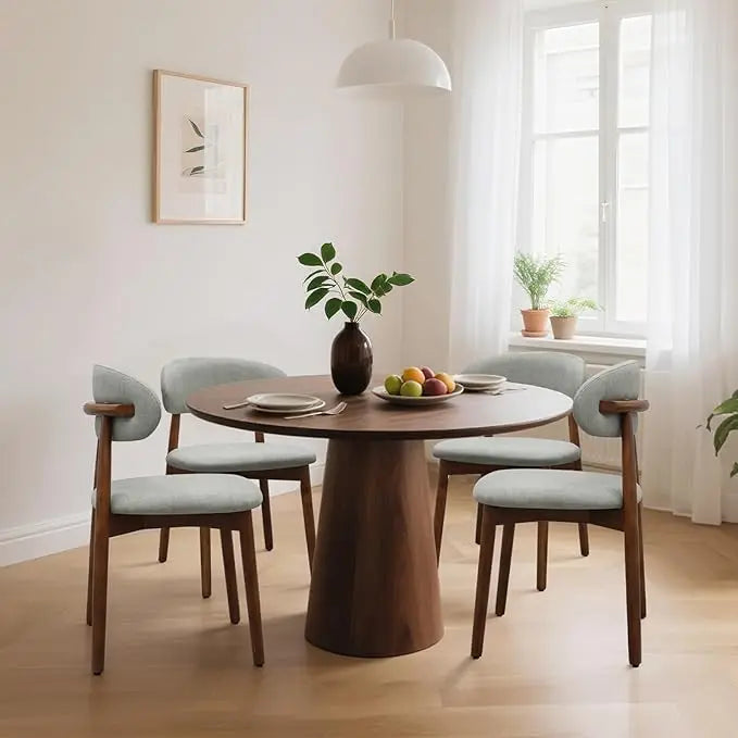 Dining room with a wooden table and chairs in a bright room.