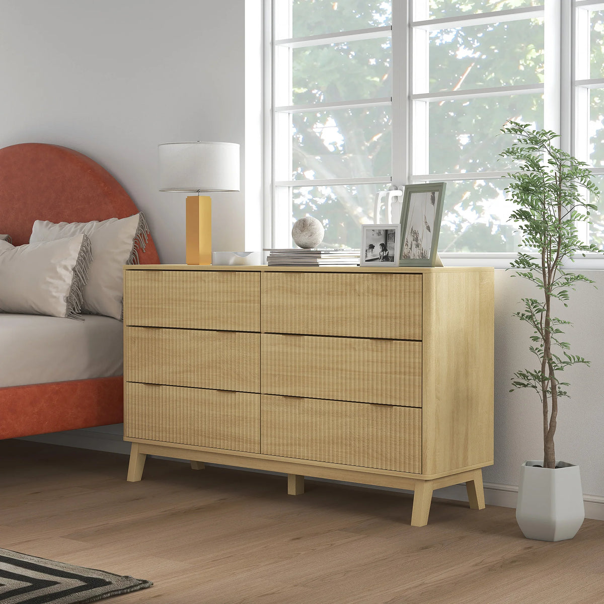 Sunbeamcrest natural-tone dresser with six closed drawers in a bedroom.