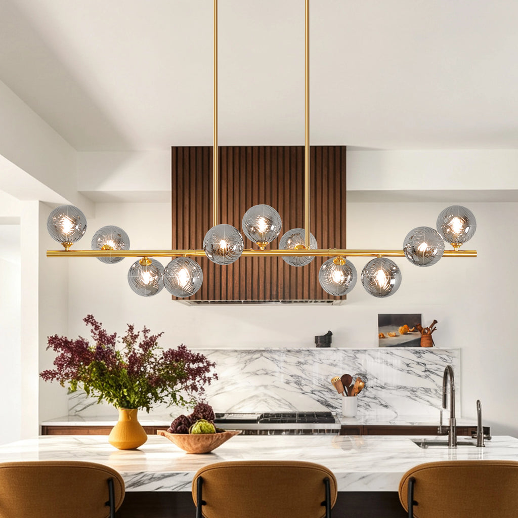 Orbstem gold-tone linear fixture with glass globes arranged above and below the bar.