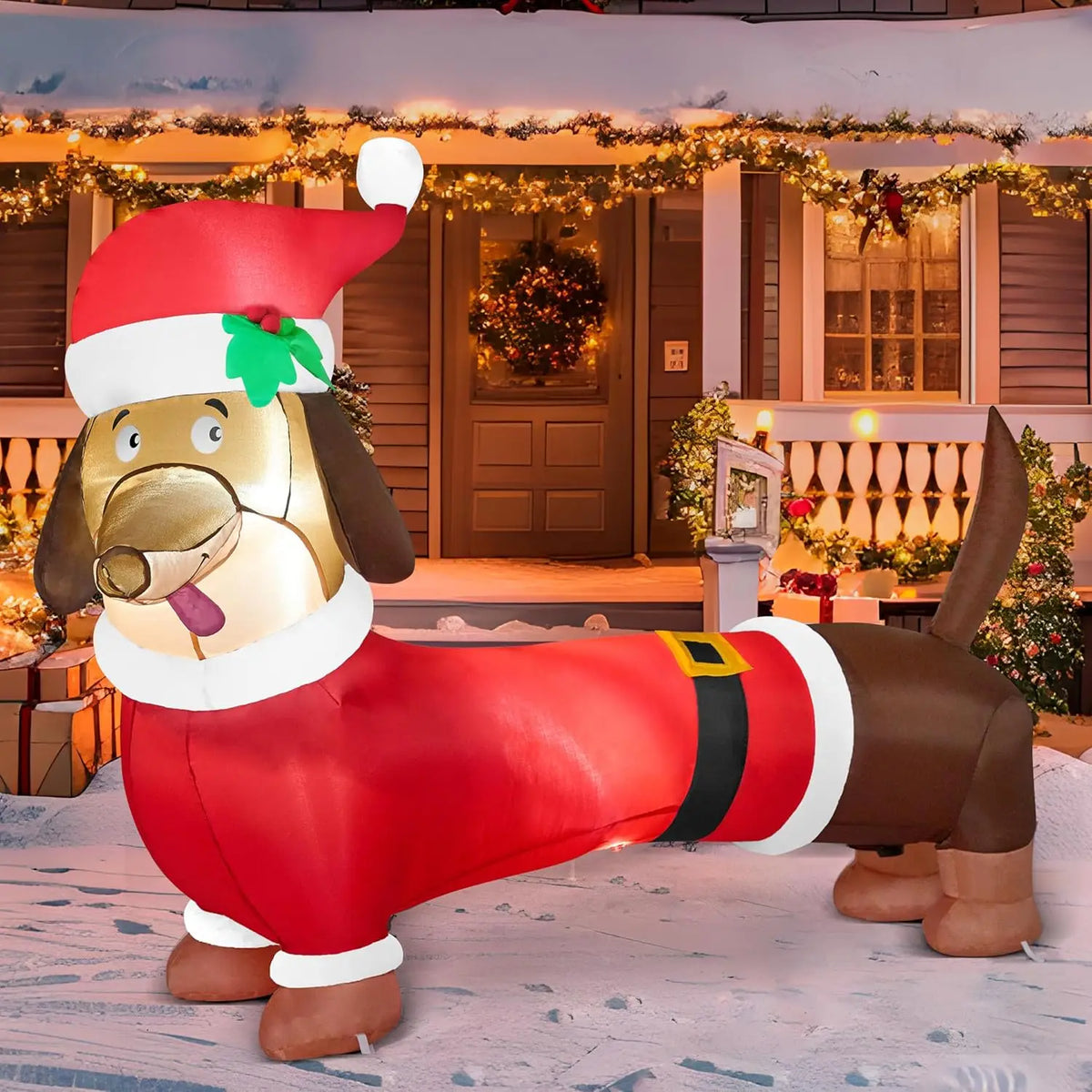 Wagglebright brown dachshund inflatable dressed in a red Santa coat and hat in a Christmas yard.