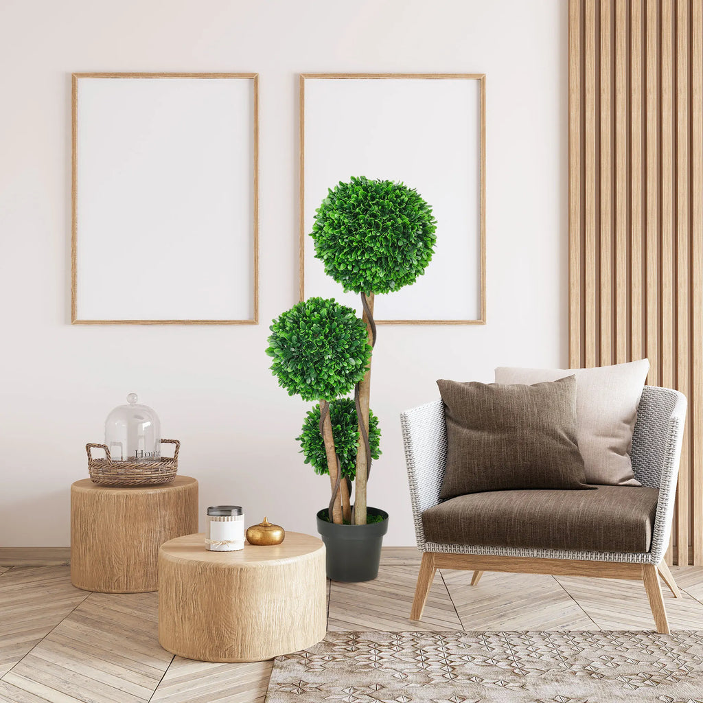 Rhymecharm three-ball artificial topiary beside a living-room chair