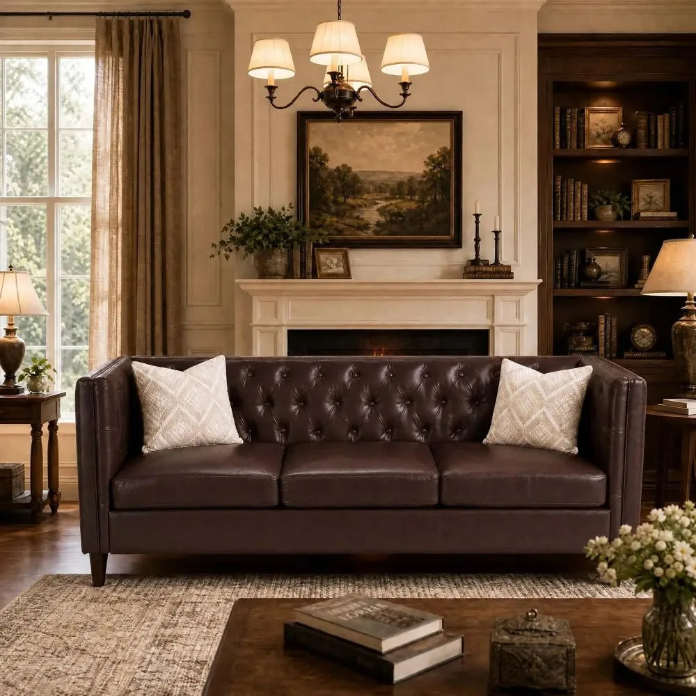 Fennwick Brown faux-leather three-seat sofa with button-tufted back and arms by fireplace