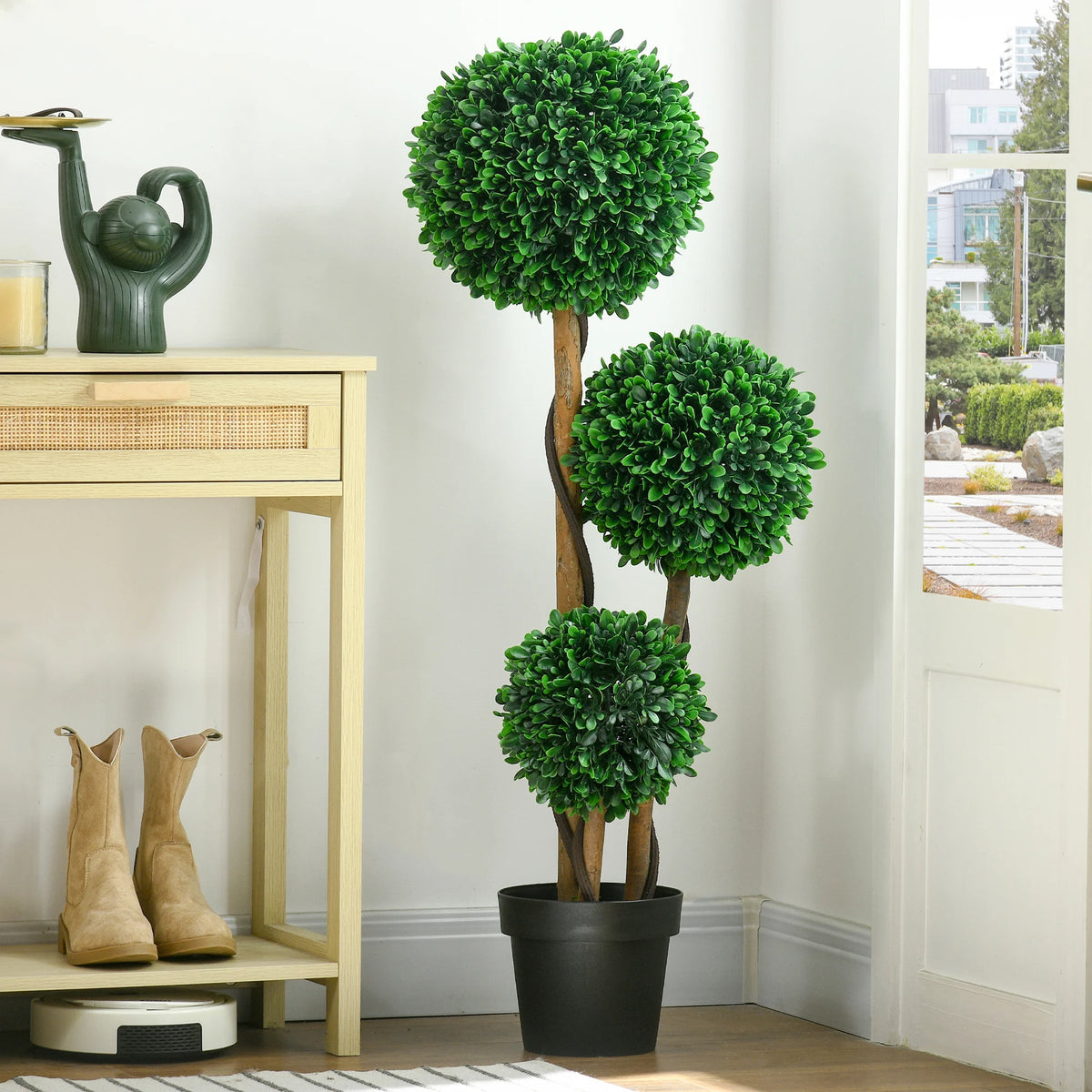 Rhymecharm three-ball artificial topiary beside an entryway table