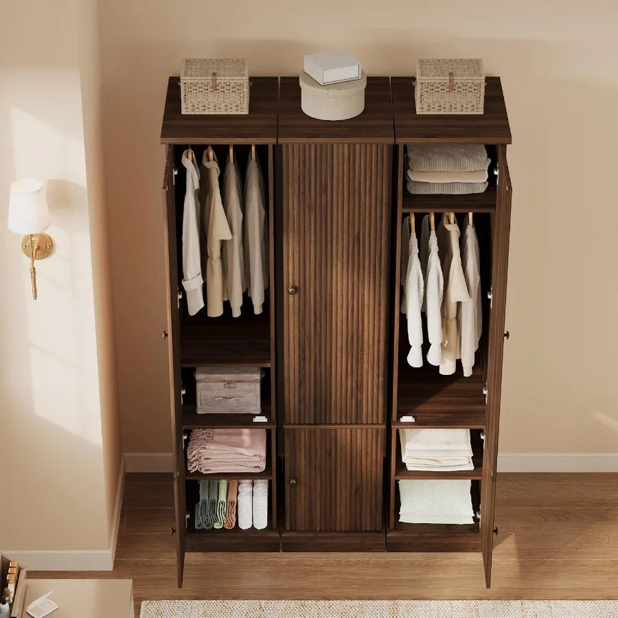 High-angle storage view of three slim wardrobes with clothes, towels, and baskets staged inside and on top.
