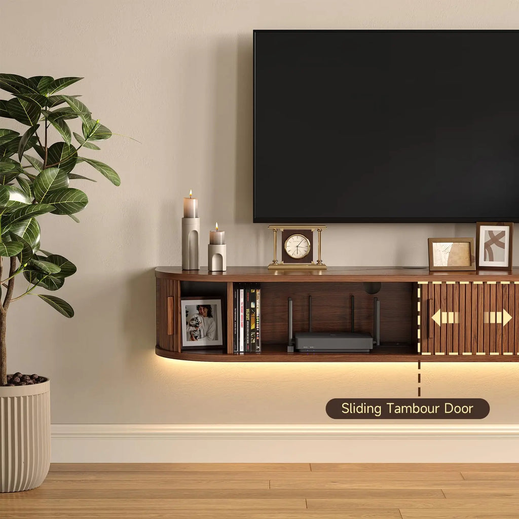 Detail of a walnut-finish cabinet with a sliding tambour door revealing storage sections and a rear cable opening.