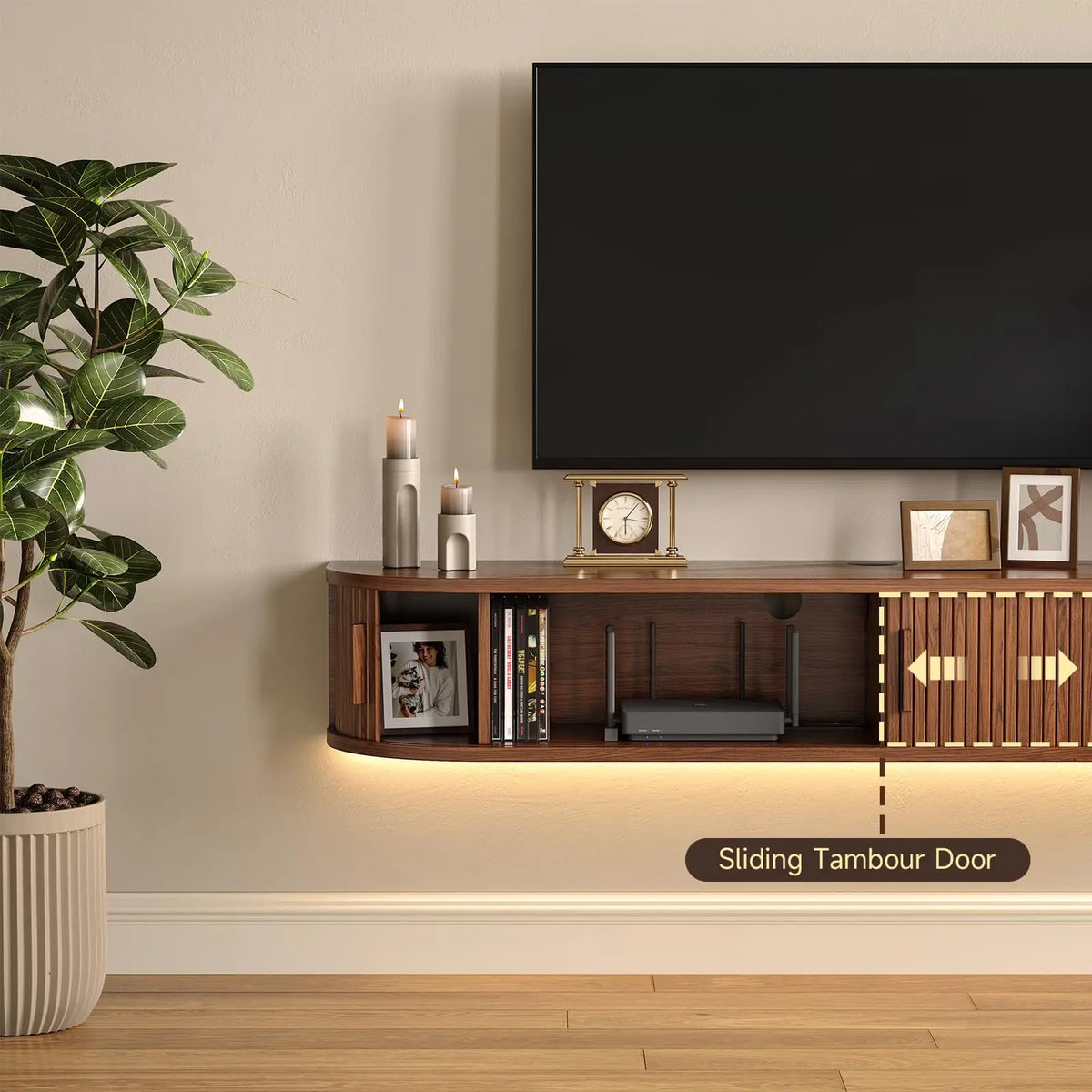 Detail of a walnut-finish cabinet with a sliding tambour door revealing storage sections and a rear cable opening.
