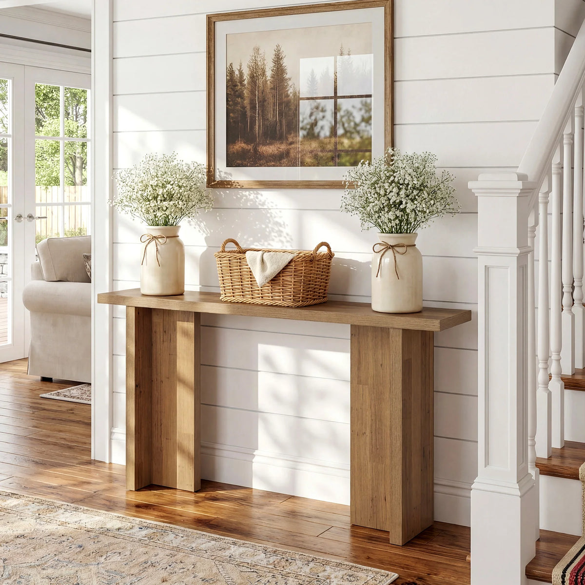 Angled view of Harmonysong console table with two flower vases and a basket staged on the rectangular top.