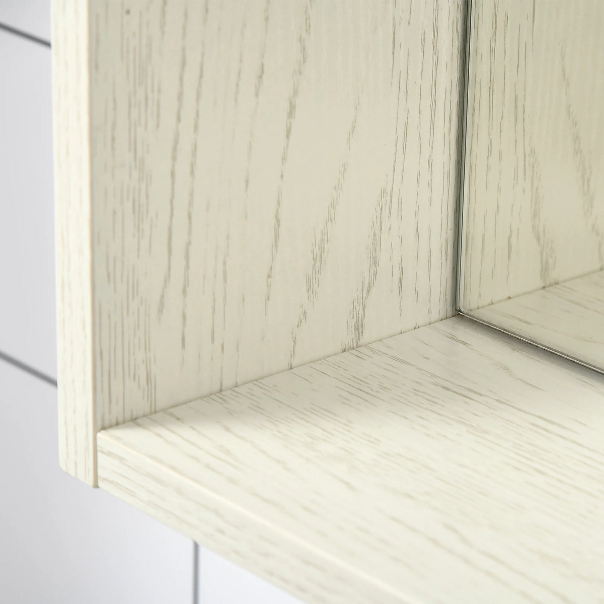 Close-up of Silhouettewhisper's white wood-grain frame, shelf and mirrored edge