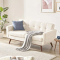 Embercoast beige tufted two-seat loveseat with wood-tone legs in living room