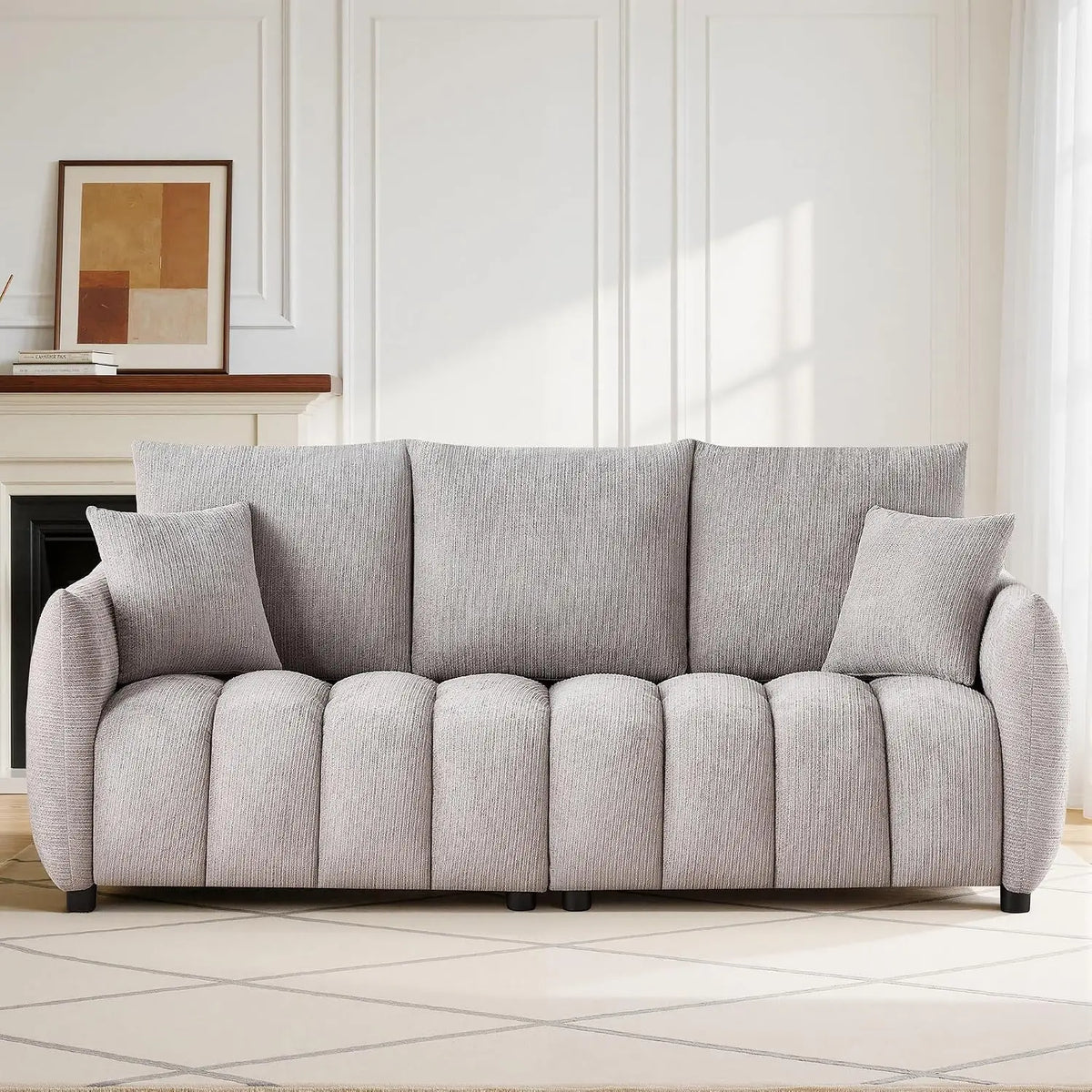 Loftelle Gray sofa with textured gray upholstery, channel-detailed seating and two matching pillows.