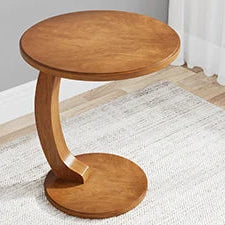 Wooden side table on a light-colored floor with a neutral background