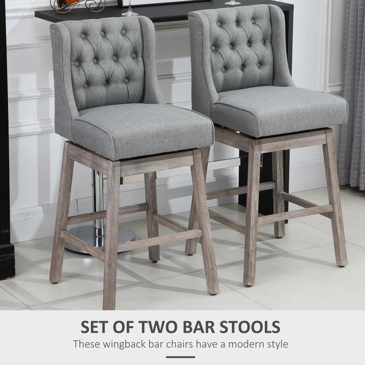 Pair of Brynleigh gray button-tufted bar stools beside a home bar