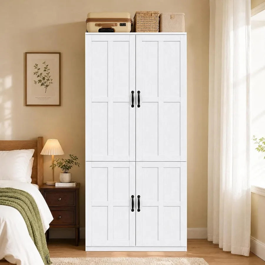 White armoire beside a bed with luggage staged on top