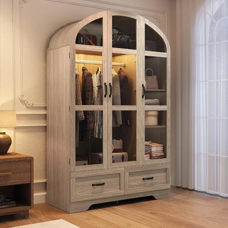 Natural wood-look arched wardrobe with three glass-front doors, warm interior lighting and two lower drawers.