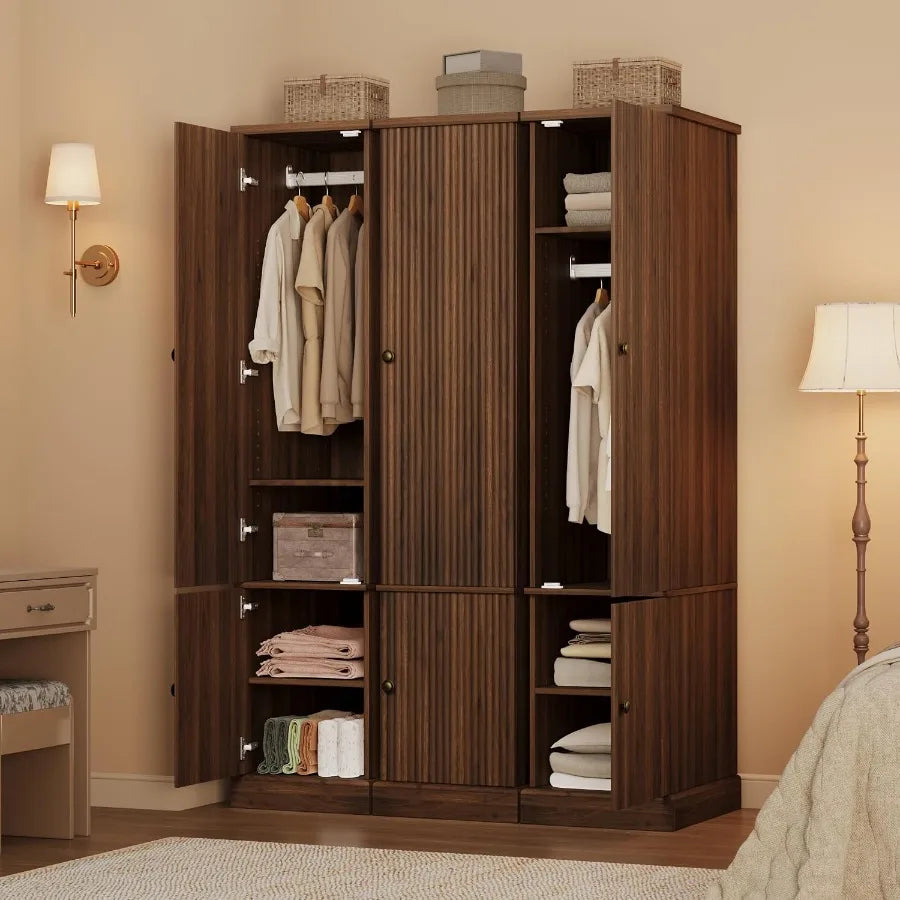 Bedroom display of three matching brown wardrobe towers, with the outer cabinets open and the center closed.